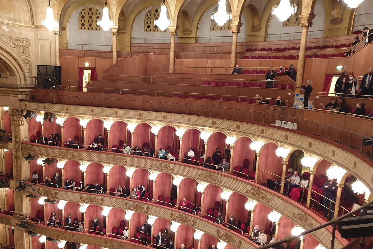 Tiers of red-and-gold boxes under chandeliers in the Teatro Costanzi, the main auditorium of Rome's opera house.